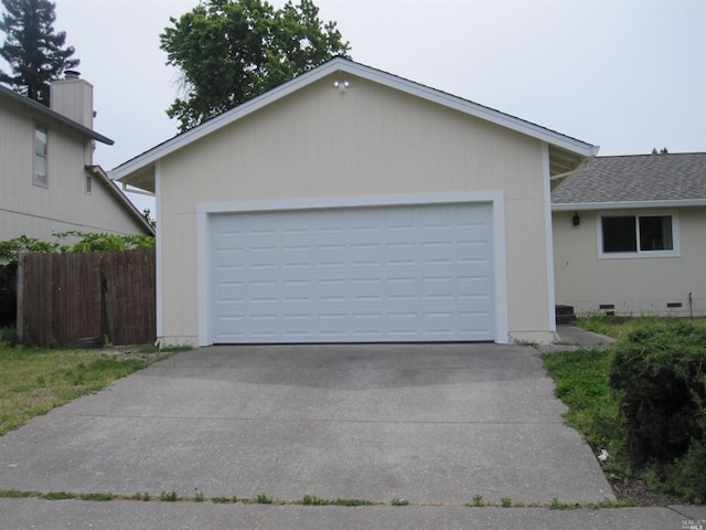 view of front of property with a garage and an outbuilding