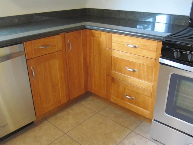 kitchen featuring stainless steel appliances and light tile patterned flooring