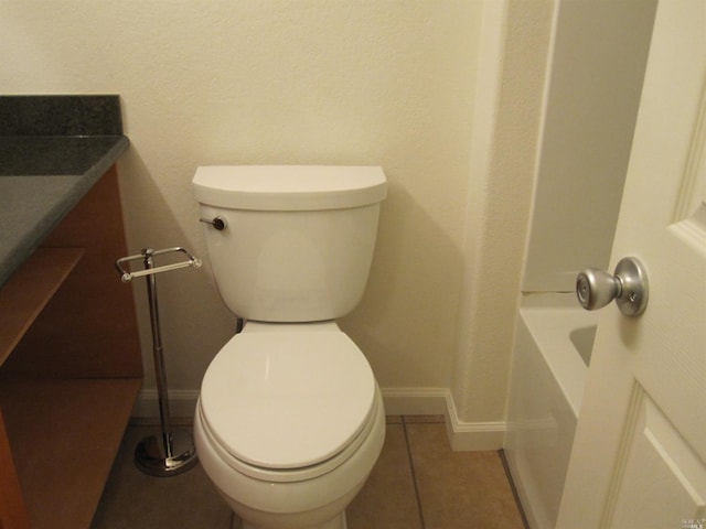 bathroom featuring toilet and tile patterned flooring