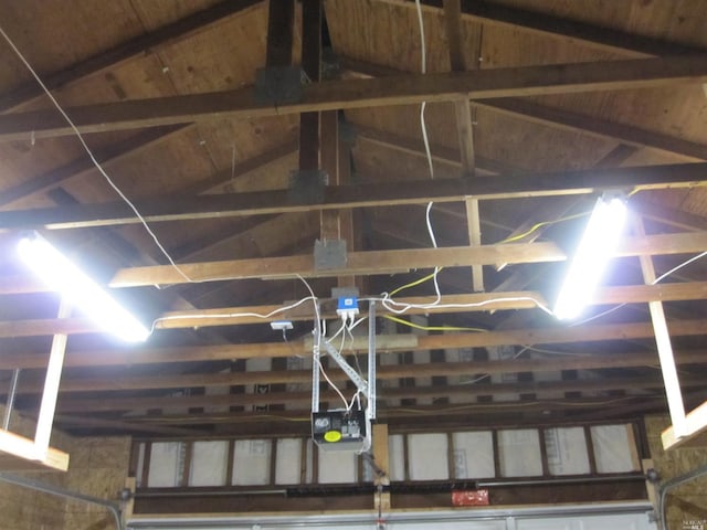 interior details featuring a garage door opener, wood ceiling, and beam ceiling