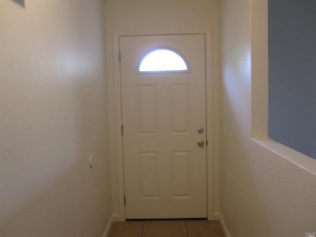 doorway featuring light tile patterned flooring