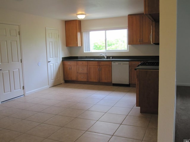 kitchen featuring sink, light tile patterned floors, and dishwasher