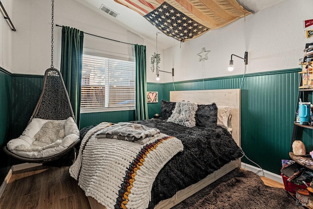 bedroom with hardwood / wood-style floors and vaulted ceiling