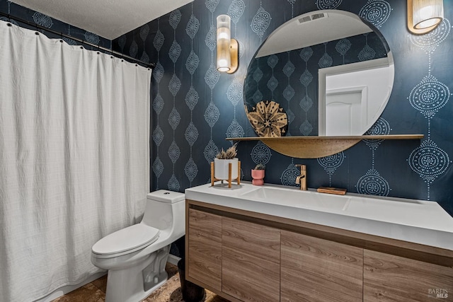 bathroom with a textured ceiling and toilet