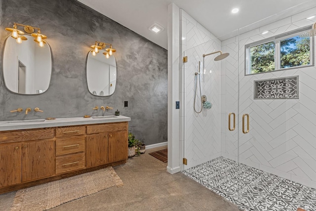 bathroom featuring a shower with door and vanity