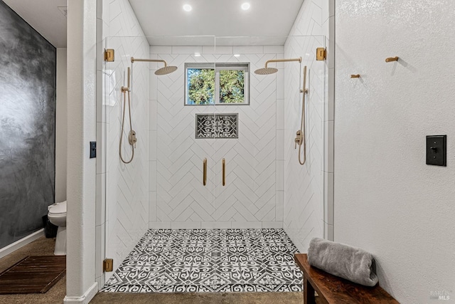 bathroom with a shower with door and toilet