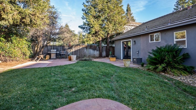 view of yard with cooling unit and a patio area