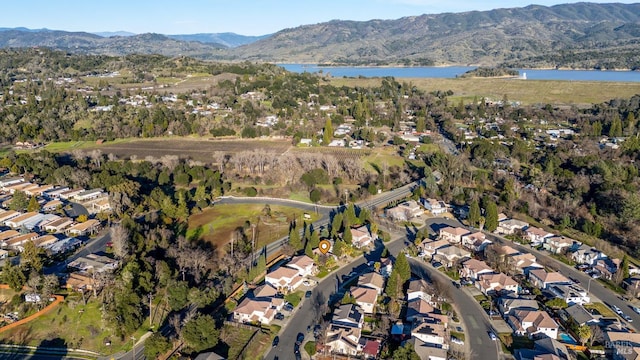 birds eye view of property featuring a water and mountain view