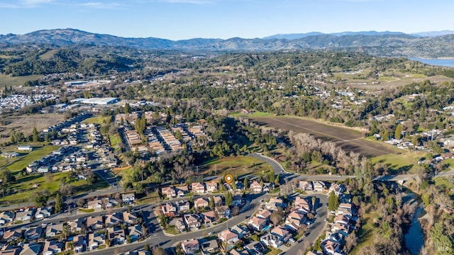 drone / aerial view with a water and mountain view