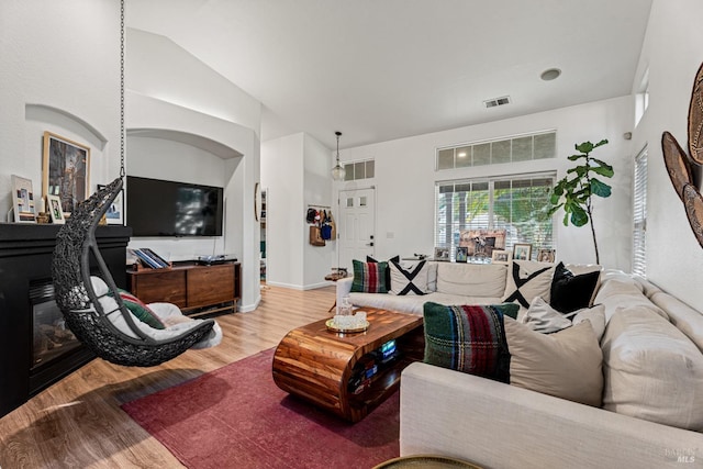 living room with hardwood / wood-style flooring and vaulted ceiling