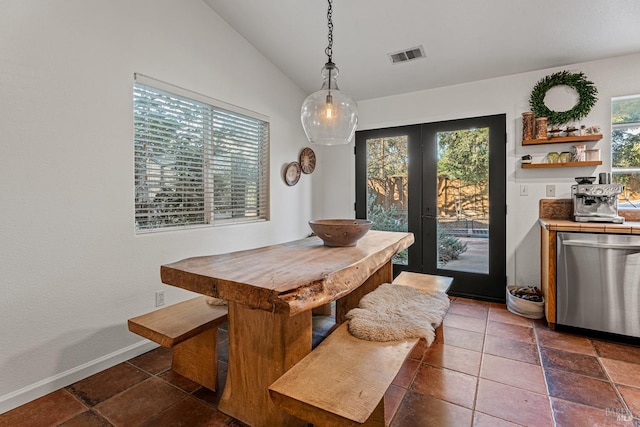 dining room with french doors and vaulted ceiling