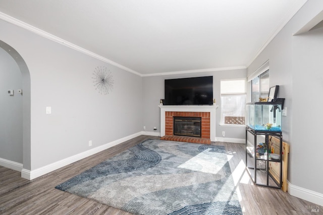 living room featuring hardwood / wood-style floors, a fireplace, and ornamental molding