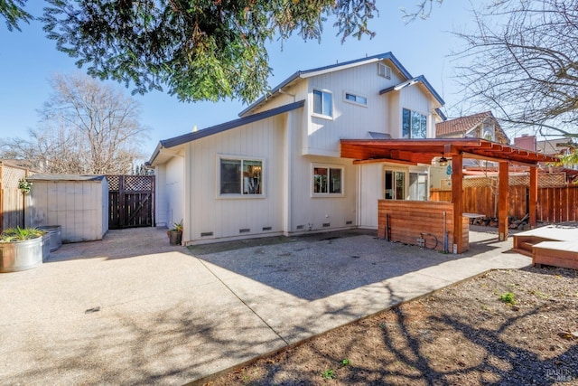 back of property with a patio area and a shed