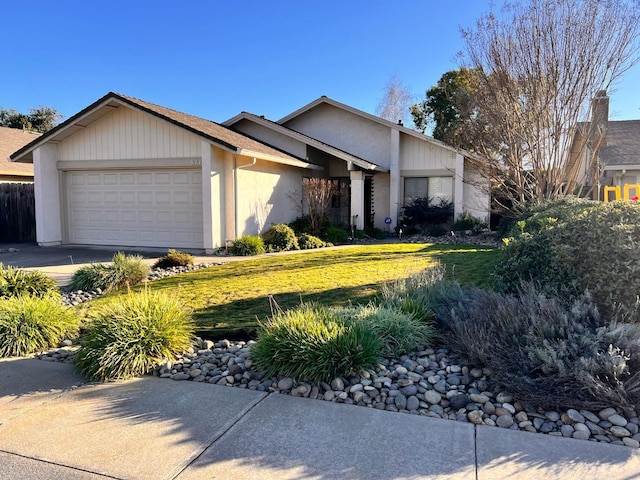 single story home featuring a garage and a front yard