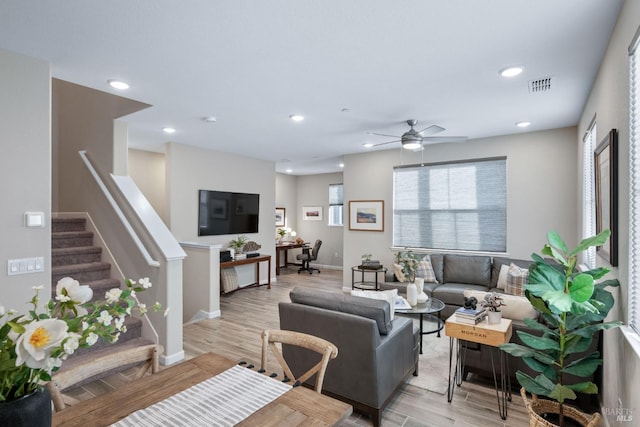 living room with stairway, recessed lighting, visible vents, and light wood-style flooring