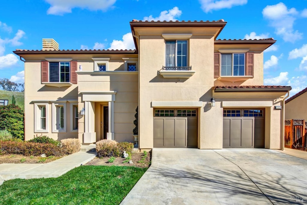 mediterranean / spanish-style home featuring a garage