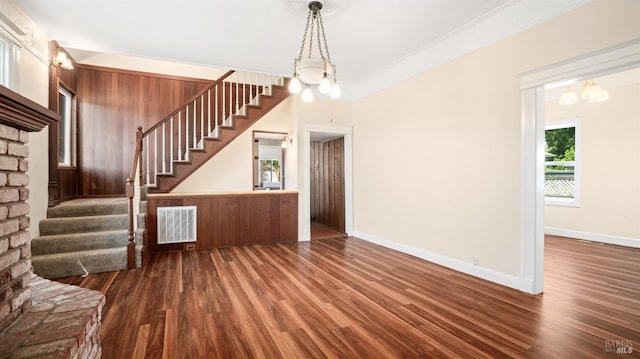 interior space featuring ornamental molding, dark wood-type flooring, and a chandelier