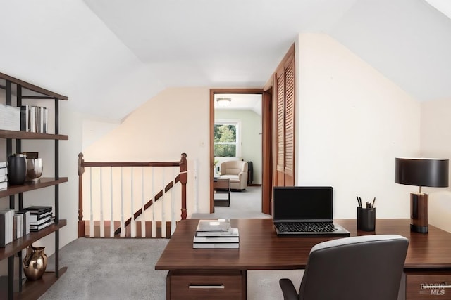 office with vaulted ceiling and light carpet