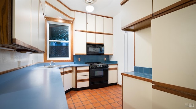 kitchen with white cabinetry, sink, backsplash, and black appliances