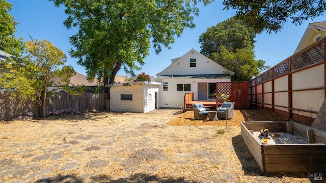 rear view of property featuring a shed