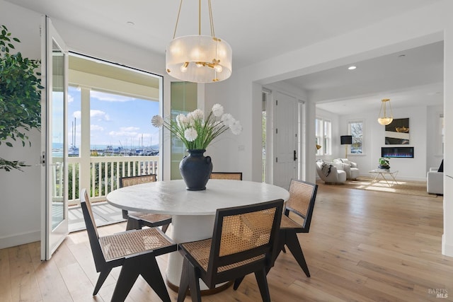 dining space with light wood-style floors, baseboards, and recessed lighting