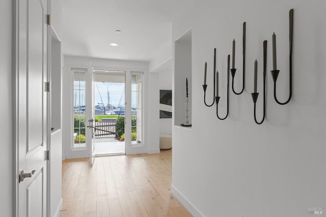 interior space with light wood-type flooring and baseboards