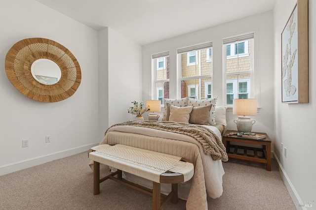 carpeted bedroom featuring baseboards