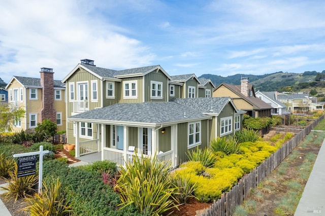 view of front of home featuring a residential view, board and batten siding, and roof with shingles