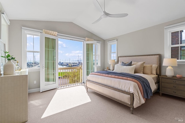 bedroom with access to exterior, multiple windows, vaulted ceiling, and carpet floors