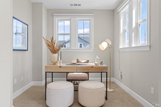 office space featuring carpet, baseboards, and visible vents