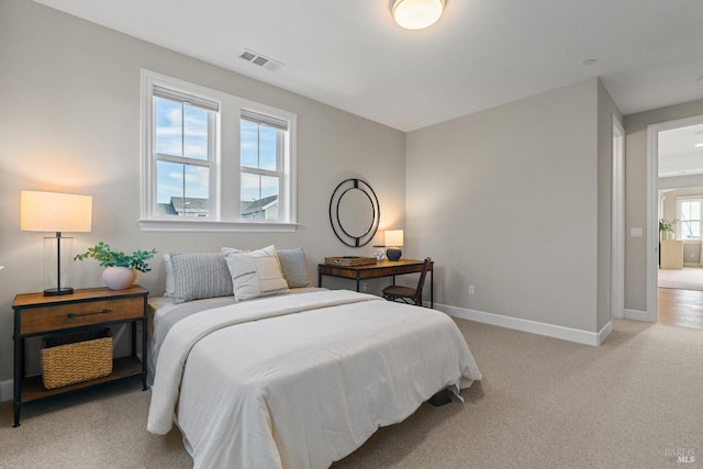 bedroom featuring light carpet, visible vents, and baseboards