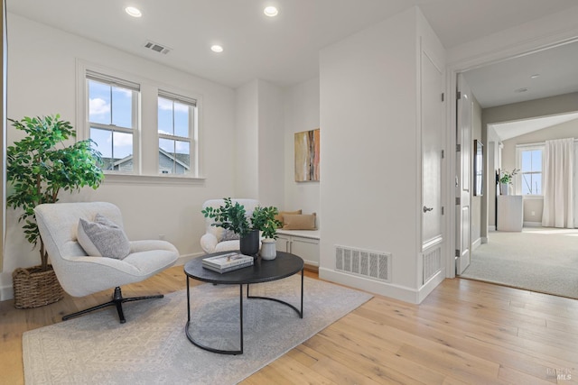 sitting room featuring light wood-type flooring, visible vents, baseboards, and recessed lighting