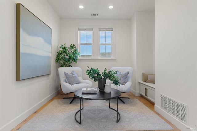 sitting room featuring recessed lighting, light wood-type flooring, visible vents, and baseboards