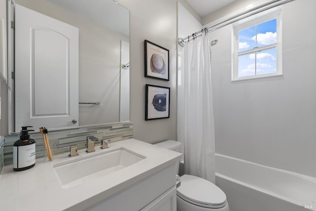 bathroom featuring tasteful backsplash, vanity, toilet, and shower / bath combo with shower curtain