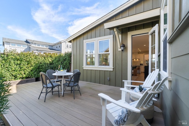 wooden terrace featuring outdoor dining area