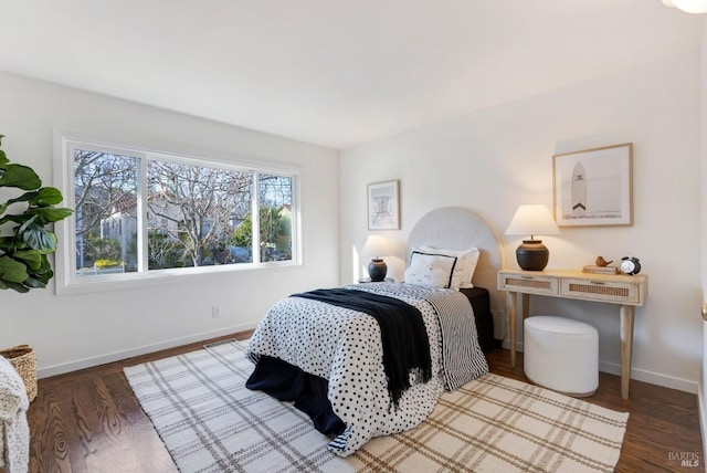 bedroom with dark hardwood / wood-style floors