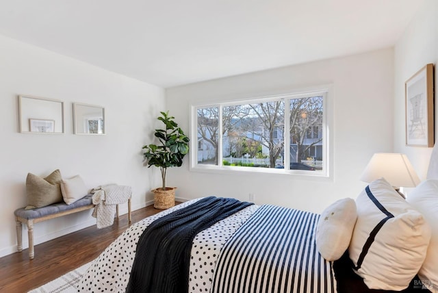 bedroom with dark wood-type flooring