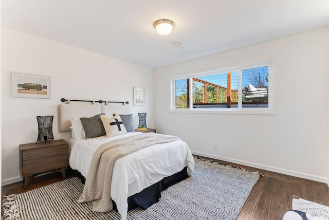 bedroom with dark hardwood / wood-style flooring