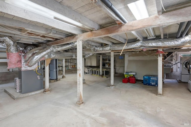 basement featuring gas water heater and washing machine and dryer