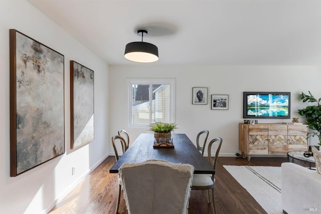 dining area with dark hardwood / wood-style flooring