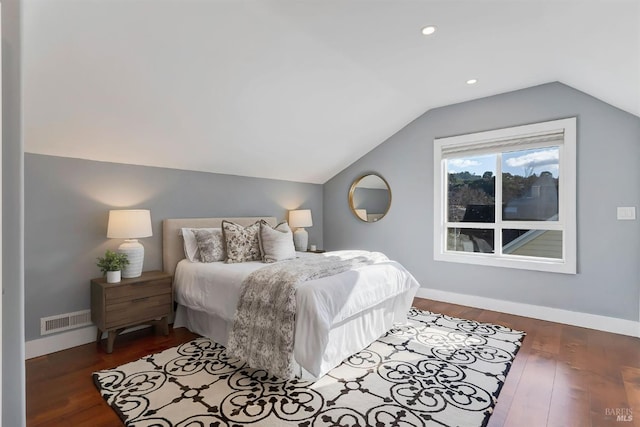 bedroom with vaulted ceiling and dark hardwood / wood-style floors