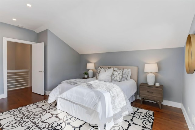 bedroom with dark wood-type flooring and vaulted ceiling