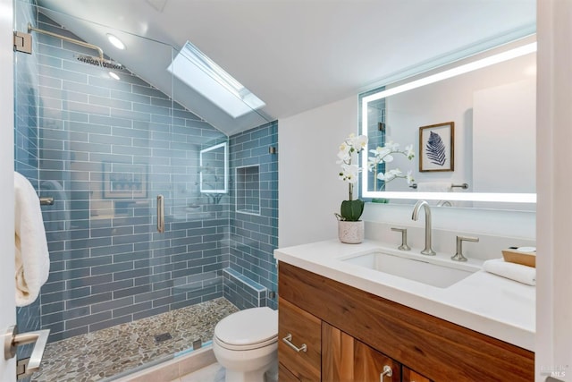 bathroom featuring walk in shower, vanity, toilet, and vaulted ceiling with skylight