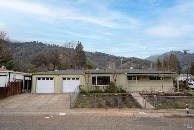 ranch-style home with a mountain view and a garage