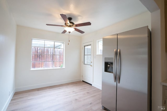 kitchen with ceiling fan, stainless steel fridge, and light hardwood / wood-style floors