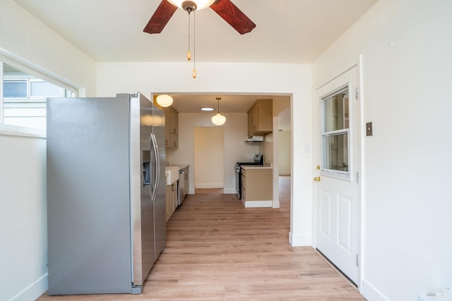 kitchen with ceiling fan, stainless steel appliances, and light hardwood / wood-style flooring