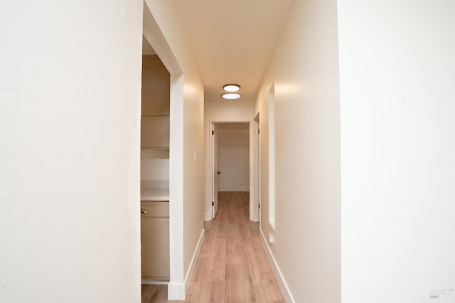 hallway with light hardwood / wood-style floors