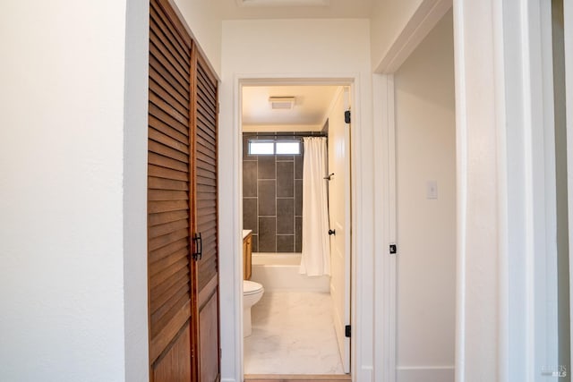 bathroom featuring shower / tub combo with curtain and toilet