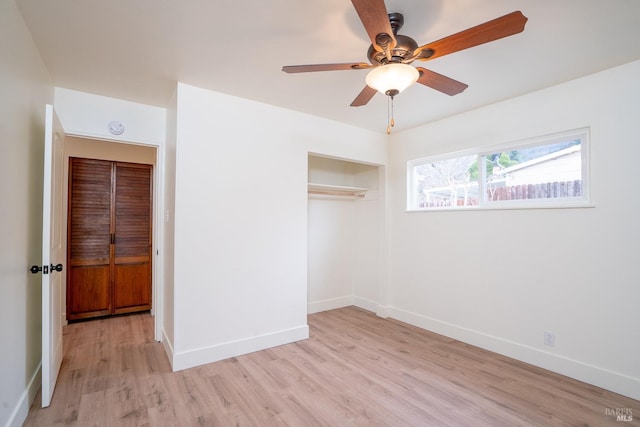 unfurnished bedroom with ceiling fan, a closet, and light wood-type flooring