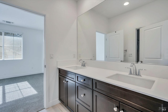 bathroom with tile patterned floors and vanity